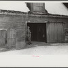 Hired man in doorway of barn on Putney Homestead near Woodstock, Vermont