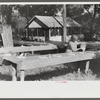 One of the food committee members fixing the table for the St. Thomas Church picnic supper, near Bardstown, Kentucky