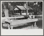 One of the food committee members fixing the table for the St. Thomas Church picnic supper, near Bardstown, Kentucky