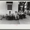 Townspeople visiting while sitting in front of Old Talbott Tavern on Saturday afternoon. Bardstown, Kentucky