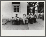 Townspeople visiting while sitting in front of Old Talbott Tavern on Saturday afternoon. Bardstown, Kentucky