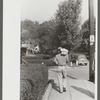 Man carrying home supplies on Saturday afternoon, Jackson, Kentucky