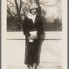 Photograph of woman in fur, white shirt and shoes