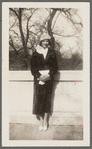 Photograph of woman in fur, white shirt and shoes