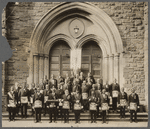 Arthur A. Schomburg and Harry A. Williamson (back row on right) in a group portrait with fellow members of the Prince Hall Grand Lodge, on the steps of Mother A.M.E. Zion Church, in Harlem, New York