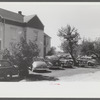 Cars parked in yard of private home across from Pratt and Whitney, United Aircraft. They charge fifty cents a week or ten cents a day. They have about 400 cars every twenty-four hours. East Hartford, Connecticut