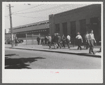 Workers entering plant at afternoon change of shift. Pratt and Whitney plant, United Aircraft, East Hartford, Connecticut