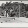 Mountain woman chatting with a friend on the bridge in Jackson, Breathitt County, Kentucky