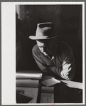 Fur buyer from New Orleans waiting for FSA (Farm Security Administration) supervisor to open the bids at auction sale of muskrats in dancehall on Delacroix Island, Louisiana