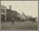 View of a busy intersection. Showing drugstore, E.J. Pray Meats,
laundry, streetcar. Hempstead