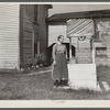 Farm woman standing by well. West Virginia