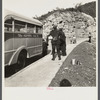 Coal miners waiting along road for bus to take them home. In Welch, Bluefield section, West Virginia