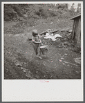 Child of miner carrying home coal she picked out of old slate pile down the hill. Pursglove, Scotts Run, West Virginia