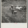 Child of miner carrying home coal she picked out of old slate pile down the hill. Pursglove, Scotts Run, West Virginia
