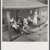 Family of man dying of T.B. gather around on front porch. Abandoned mining town, Marine, West Virginia