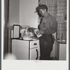 A more well-to-do miner starts his breakfast when he comes home in the morning after working on the night shift. He is Polish, his wife Hungarian. Westover, West Virginia