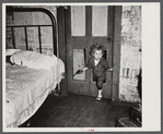 Why open the door, coal miner's child uses the "cat hole." Bertha Hill, West Virginia (Note pipe in one hand, gun in other)