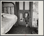 Why open the door, coal miner's child uses the "cat hole." Bertha Hill, West Virginia (Note pipe in one hand, gun in other)