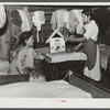 Indian girl and her sister showing house she made. The entire one-room house she lives in is completely filled with beds for the large family. Near Pembroke Farms. Maxton, North Carolina
