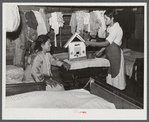 Indian girl and her sister showing house she made. The entire one-room house she lives in is completely filled with beds for the large family. Near Pembroke Farms. Maxton, North Carolina