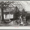 Negro rehabilitation client mixing cement to be used in construction of his new home near Raleigh, North Carolina