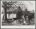 Negro rehabilitation client mixing cement to be used in construction of his new home near Raleigh, North Carolina