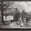 Negro rehabilitation client mixing cement to be used in construction of his new home near Raleigh, North Carolina