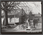 Negro rehabilitation client mixing cement to be used in construction of his new home near Raleigh, North Carolina