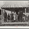 Negro family (rehabilitation clients) on porch of new home they are building near Raleigh, North Carolina