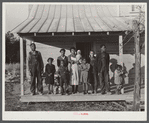 Negro family (rehabilitation clients) on porch of new home they are building near Raleigh, North Carolina