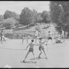 Performers in shorts rehearsing fight choreography outside with sticks for the stage production Henry IV, Part I at the Delacorte Theater
