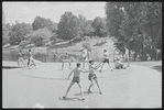 Performers in shorts rehearsing fight choreography outside with sticks for the stage production Henry IV, Part I at the Delacorte Theater