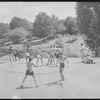 Performers in shorts rehearsing fight choreography outside with sticks for the stage production Henry IV, Part I at the Delacorte Theater