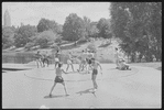 Performers in shorts rehearsing fight choreography outside with sticks for the stage production Henry IV, Part I at the Delacorte Theater