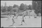 Performers in shorts rehearsing fight choreography outside with sticks for the stage production Henry IV, Part I at the Delacorte Theater