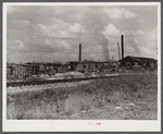 Small sawmill, Childs, Florida. Owned by "wealthy" man, Mr. Warren, in Fort Meade, Florida. Negro workers build their own shacks out of old lumber from around there, work ten hours a day for two dollars, six days a week. The children don't go to school