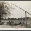 Well and mud vat for cooking sorghum syrup in front yard of Indians home near Summerville, South Carolina