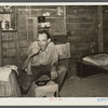 Migrant agricultural worker from Tennessee, formerly a railroad man, eating dinner in his shack, an old tool house. Homestead, Florida