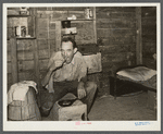 Migrant agricultural worker from Tennessee, formerly a railroad man, eating dinner in his shack, an old tool house. Homestead, Florida