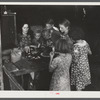 Woman migrant packinghouse worker from Tennessee with four children and two relatives eating supper. Belle Glade, Florida