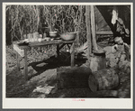 Table for eating and washing outside migrant packinghouse worker's shack. Belle Glade, Florida
