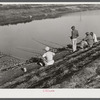 Migratory workers fishing to eat. Belle Glade, Florida