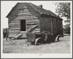 Deserted tenant farmer's shack and old car. Greene County, Georgia