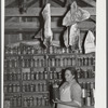Mrs. Brown in her smokehouse with home-canned goods and cured meat. Prairie Farms, Alabama