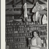 Mrs. Brown in her smokehouse with home-canned goods and cured meat. Prairie Farms, Alabama