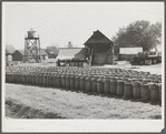 Turpentine still with barrels of resin in foreground. Iron City, Alabama