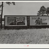 Highway signs by lumber planing mill. Cairo, Georgia