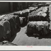 Burst bales of cotton on street near warehouse in Montgomery, Alabama