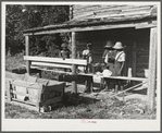 Pauline Clyburn, rehabilitation client, and her children stringing tobacco. Manning, Clarendon County, South Carolina