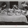 Helms family at dinner which consists of roast beef (home canned), turnip greens, potatoes, biscuits, corn bread, butter, milk, peaches, and cake. Coffee County, Alabama